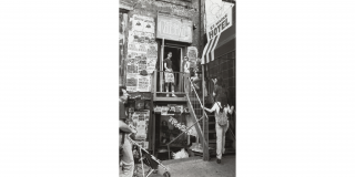 Historic photo of people outside of a shop on St. Marks