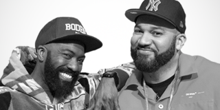 Grayscale headshot of Desus and Mero wearing baseball caps